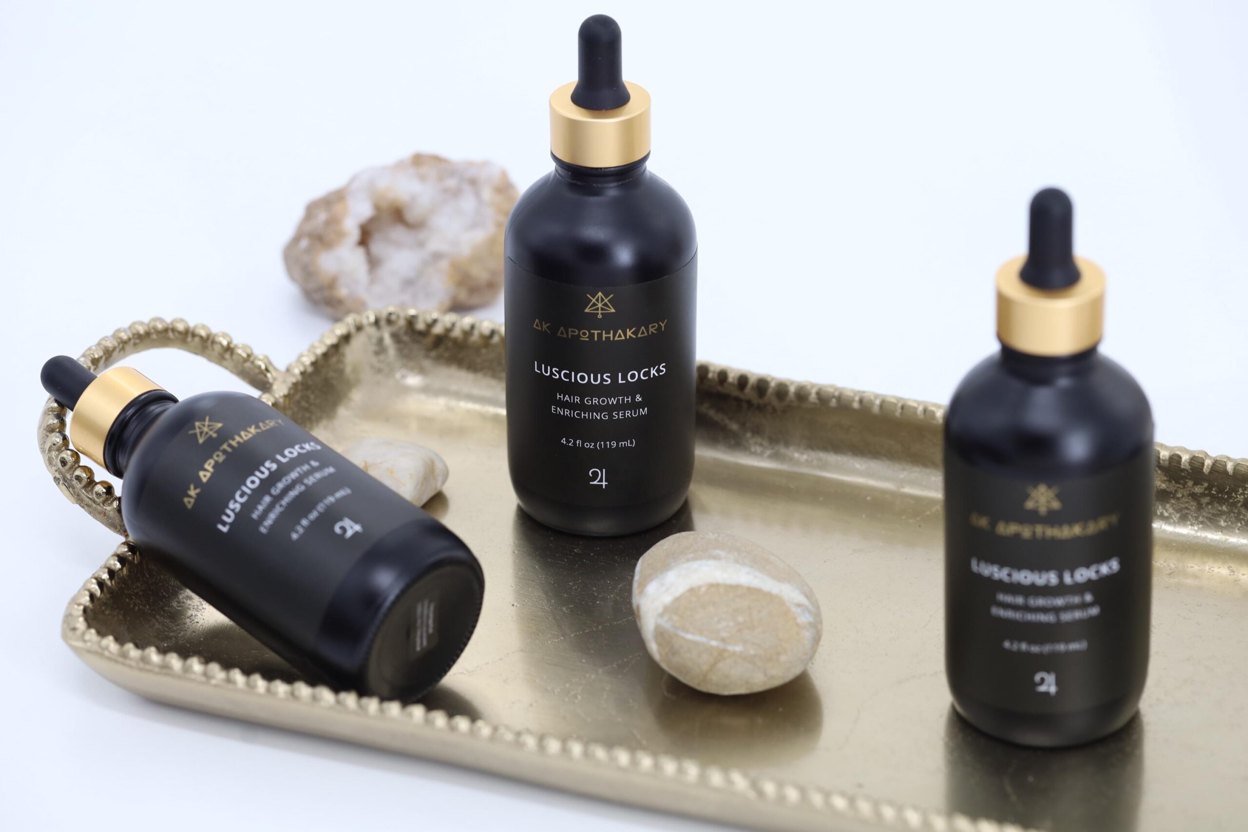 Three bottles of Luscious Locks o a tray.