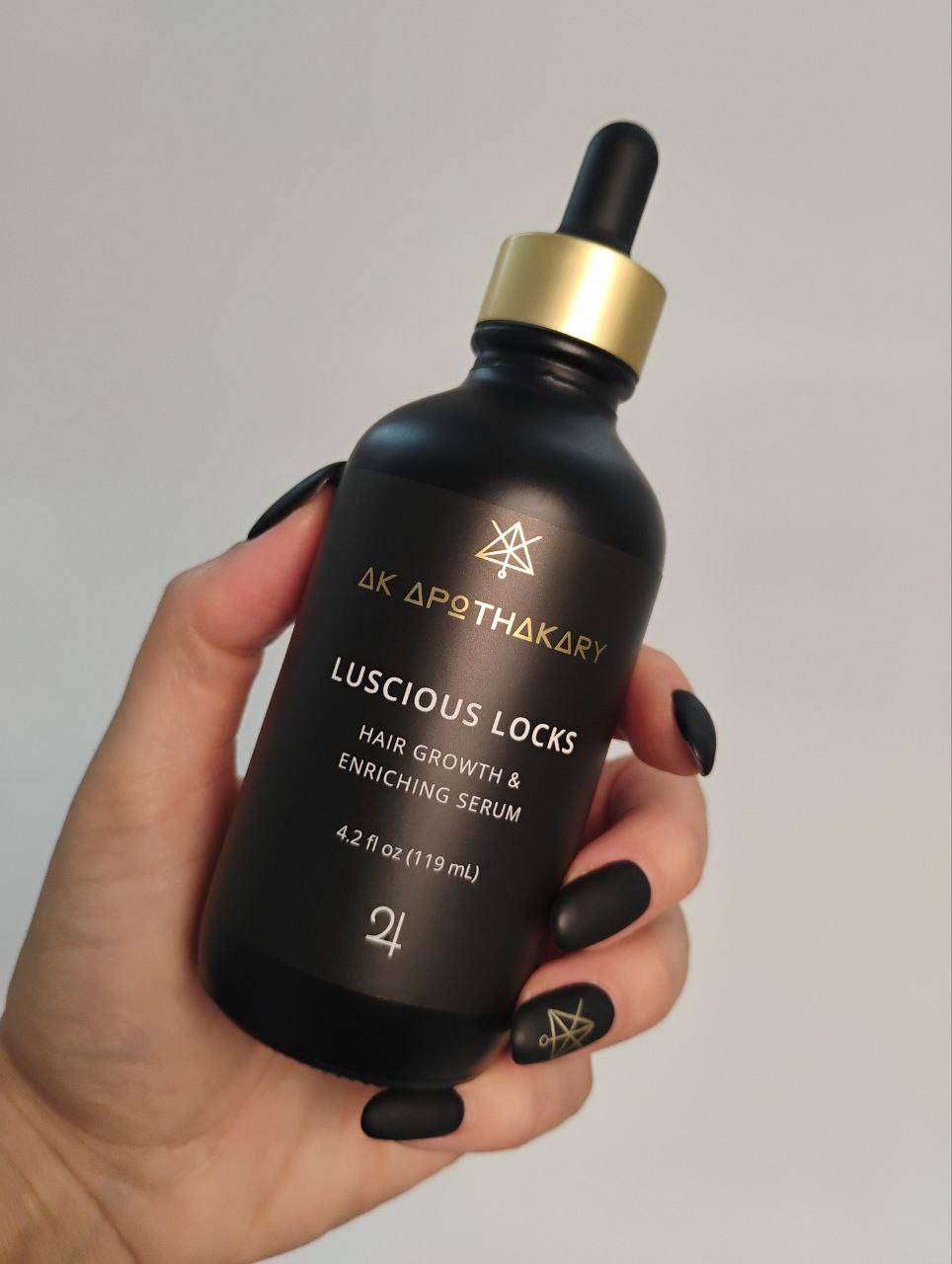 A hand holds a bottle of Luscious Locks.