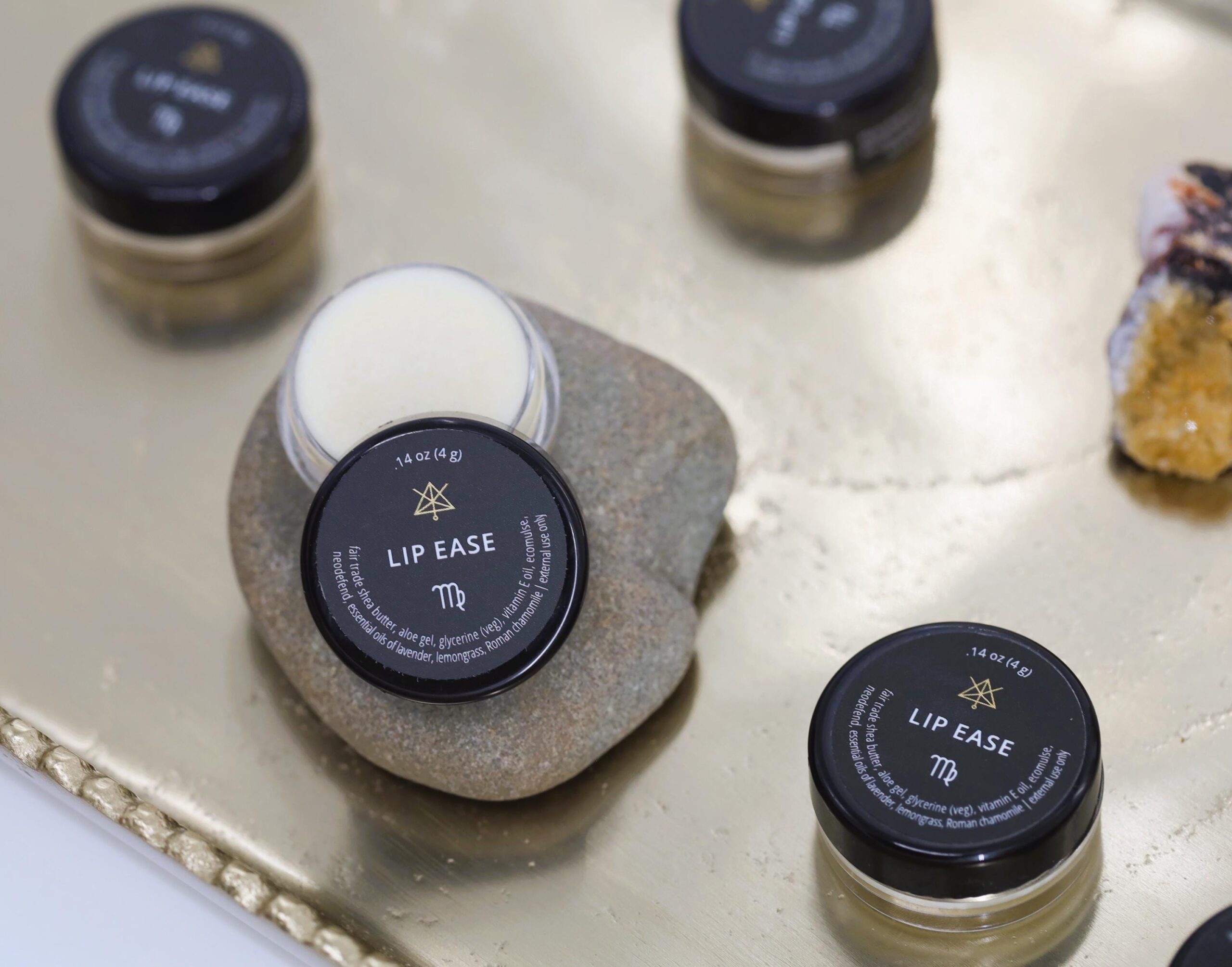 Several jars of Lip Ease on a tray.