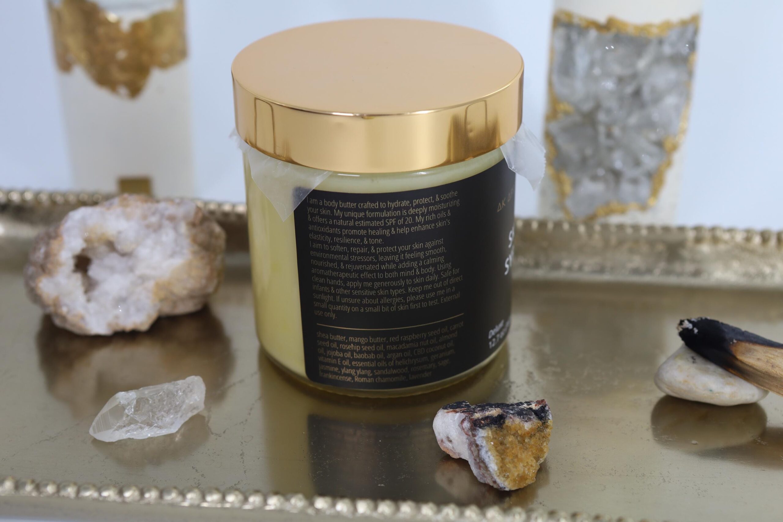 Skin Syrup sits on a gold tray with the ingredients listed on the jar visible.